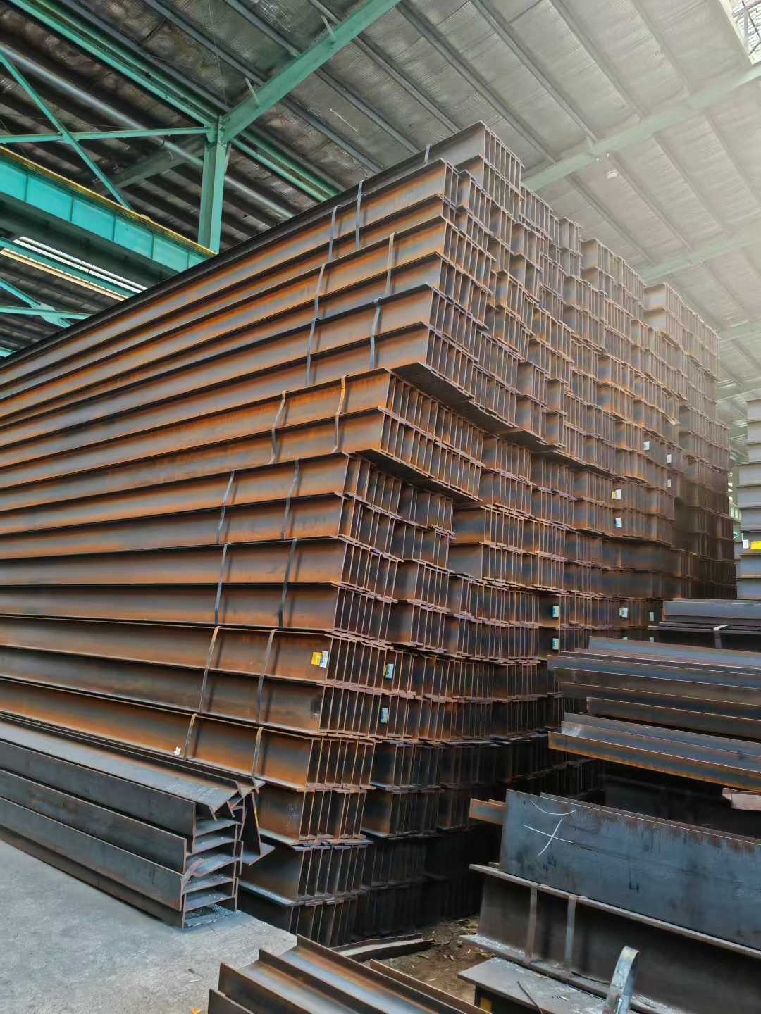 H-beams are stacked at the factory. H-beams are stacked at the factory.